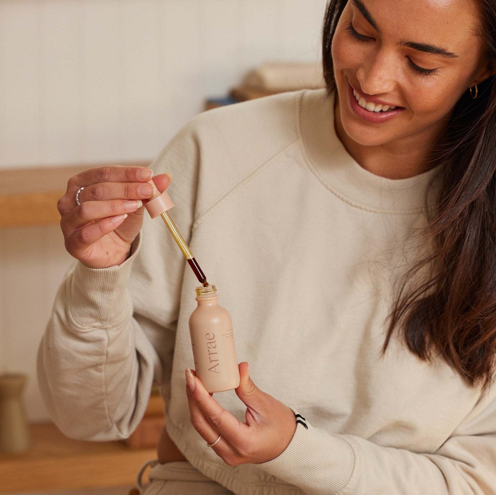 Woman squeezing Arrae Gut Boost tincture