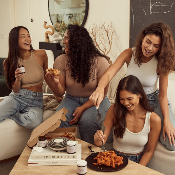 Group of women holding Arrae and eating food