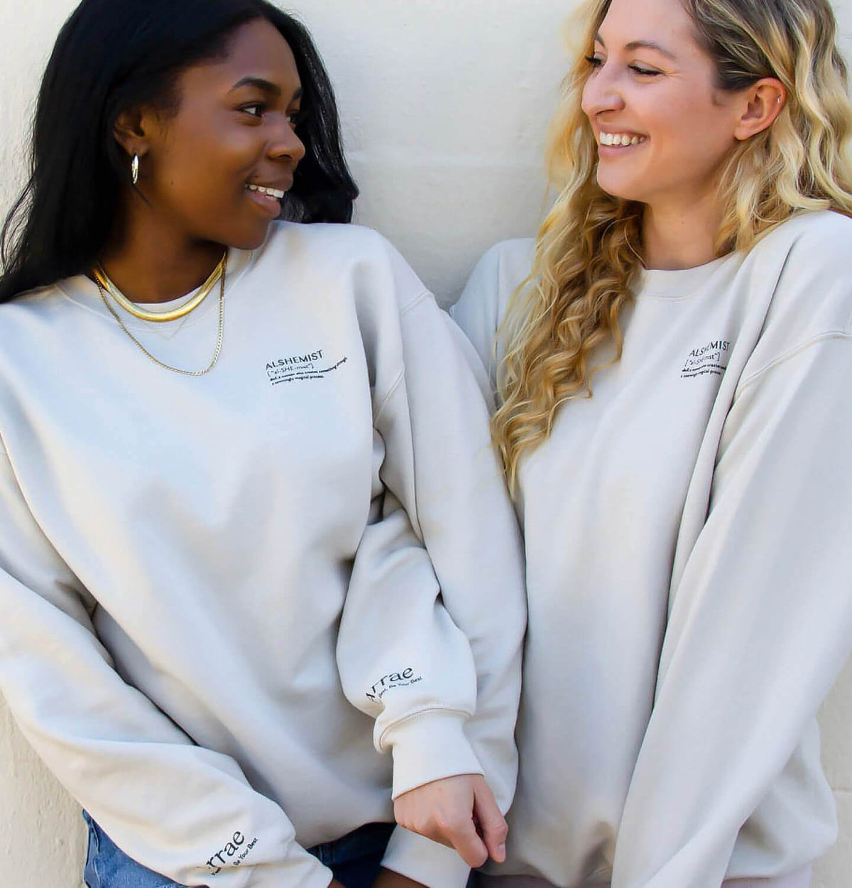 2 women wearing Arrae Alshemist Sweatshirt